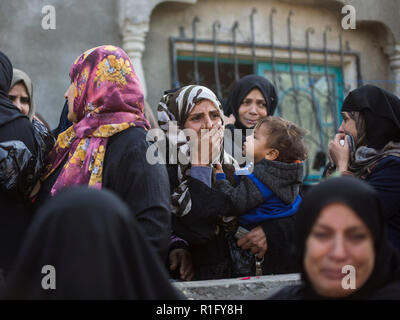 Gaza, Palestine. 12th Nov 2018. Relatives of Palestinian Mostafa Hassan Abu Odeh, who was killed in an Israeli air strike, mourn during his funeral, in Khan Younis. Credit: SOPA Images Limited/Alamy Live News Stock Photo