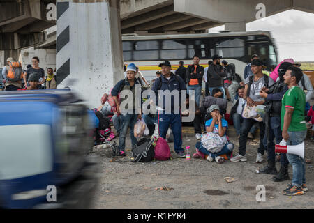 Irapuato, Guanajuato, Mexico. 12th Nov 2018. Honduran refugees with the Central American migrant caravan wait for a ride under a highway overpass to continue their journey northwest toward the U.S. border November 12, 2018 in Irapuato, Guanajuato, Mexico. The caravan has been on the road for a month is half way along their journey to Tijuana. Credit: Planetpix/Alamy Live News Stock Photo