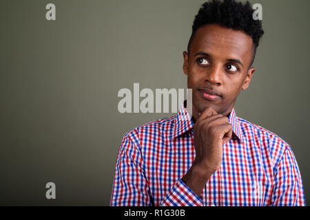 Young handsome African businessman against colored background Stock Photo