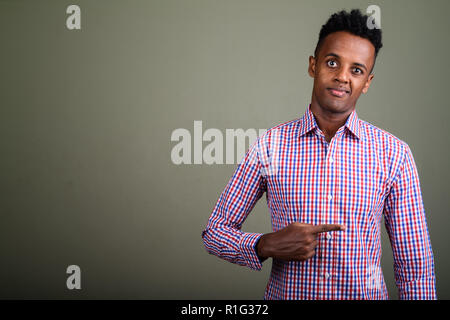 Young handsome African businessman against colored background Stock Photo