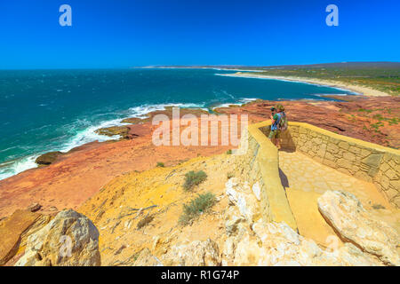 Travel photographer with stabilizer takes shot at Red Bluff lookout, Kalbarri National Park, Western Australia. Professional videomaker takes photo of Australian Coral Coast on Indian Ocean.Copy space Stock Photo