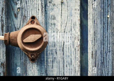 Retro toned picture of an old switch on wooden wall, selective focus, color toning applied. Stock Photo