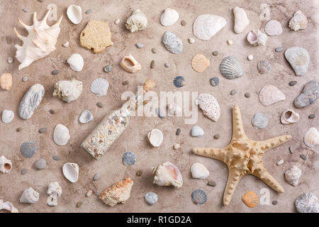 Maritime theme and a message in a bottle on a textural background. Concept of flat lay. Stock Photo