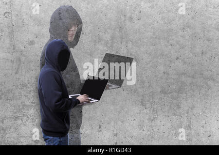 two-faced hacker hood and shadow with a face on a concrete background Stock Photo