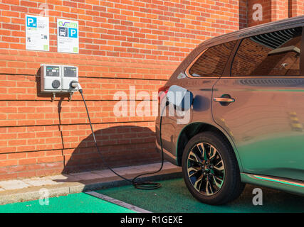 Mitsubishi outlander PHEV plugged in and charging at an EV Driver EV electric car charging point hybrid car charging Aldeburgh Suffolk England UK Stock Photo