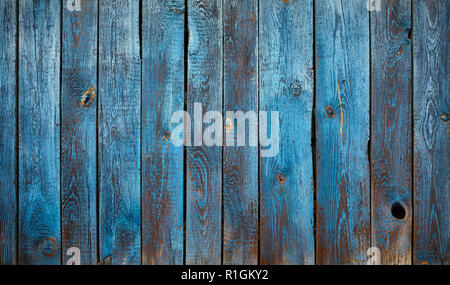 Old wooden wall with peeling blue paint, background or texture. Stock Photo