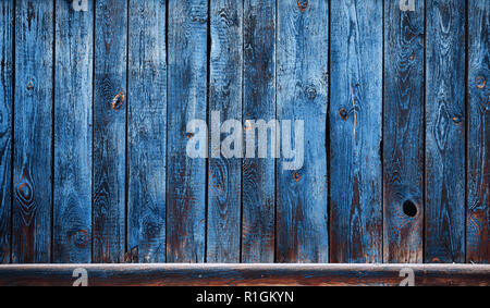 Old wooden wall with peeling blue paint, background or texture. Stock Photo