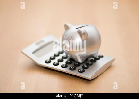 Piggy bank on calculator. Saving, accounting or banking concept. Stock Photo