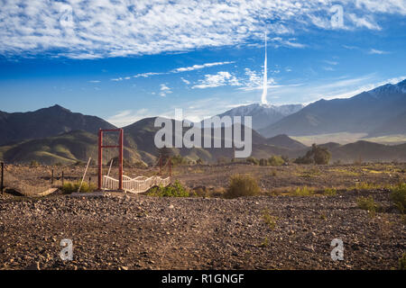 Landscape of Elqui Valley with a bridge in Vicuña, Chile. The mountains, river and clouds Stock Photo