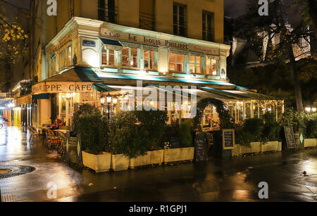 The traditional French cafe Louis Philippe at rainy night , Paris, France. Stock Photo