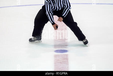 Ice Hockey referee a puck in your hand Stock Photo