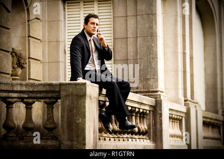 Low angle view of a man taking on his phone. Stock Photo