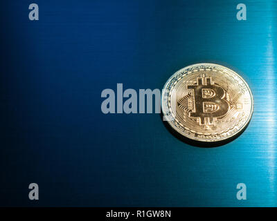 gold bitcoin crypto currency on polished shiny metal surface. high angle shot with copy space for text Stock Photo