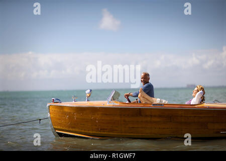 Happy mid-adult couple on a boat together on the ocean. Stock Photo