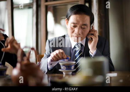 Mid-adult man having tea in a cafe. Stock Photo