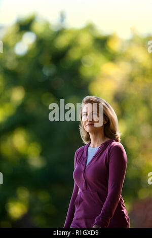 Middle aged woman walking in the park. Stock Photo