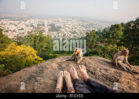 Couple legs sitting at Arunachala mountain view, Tiruvannamalai, Tamil Nadu, India Stock Photo