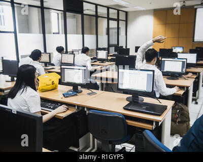 Samut Prakan, Thailand - November, 2018: Engineering students of Assumption University working in computer laboratory on their programming project Stock Photo