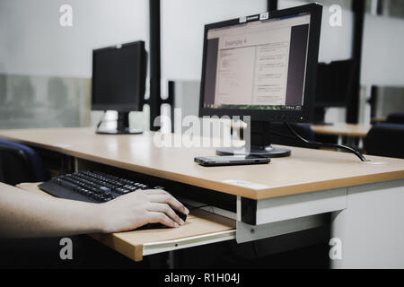 Samut Prakan, Thailand - November, 2018: Engineering students of Assumption University working in computer laboratory on their programming project Stock Photo