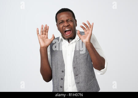 Disgusted young african american man grimacing, looking in terror and disgust, feeling averse to do something Stock Photo