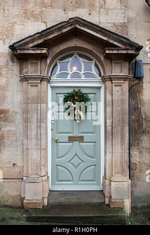 Traditional Christmas wreath on the front door of an old Georgian stone house. Stock Photo