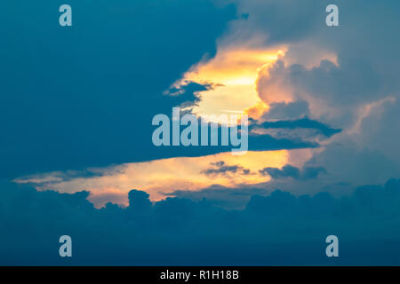 Dramatic golden hour sky with beautiful clouds, colorful cloudscape with shapes and copy space, light and dark spots, photographed in Bulgaria near vi Stock Photo