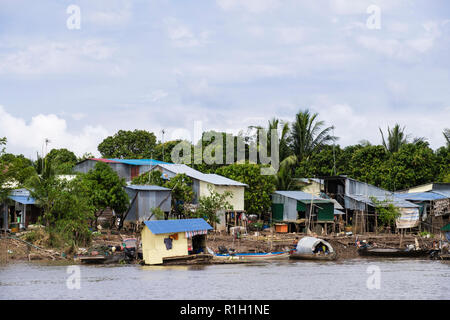Typical tin houses shacks on stilts in fishing village along Mekong River. Cambodia, southeast Asia Stock Photo
