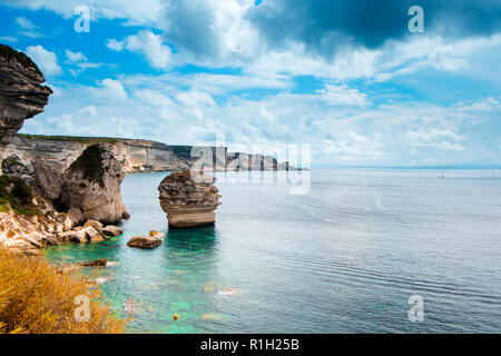 a view of the picturesque landscape of cliffs over the Mediterranean sea in Bonifacio, Corse, in France, highlighting the famous Grain de Sable sea st Stock Photo