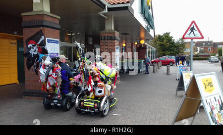 Two Motability Scooter drivers outside Morrisons Supermarket in Skegness, Lincolnshire, UK Stock Photo