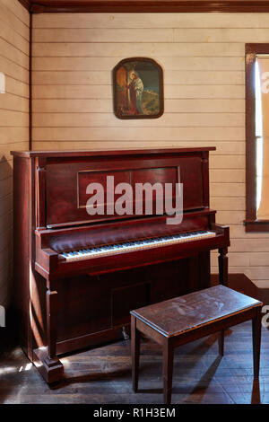 Picture of Jesus Christ above an upright piano in the East Tupelo First Assembly of God church at the Elvis Presley Birthplace museum Stock Photo
