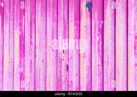 Pink rusted metal door with peeling paint Stock Photo