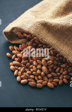 Pinto beans in burlap sack, healthy legume beans, selective focus Stock Photo