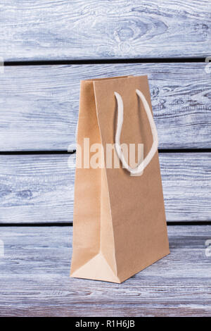 Brown paper shopping bag with white handles. Stock Photo