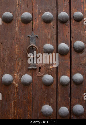Arcos de la Frontera historical centre, Cadiz, Andalusia, Spain. Detail of typical old medieval, wood and iron studded door detail. Stock Photo