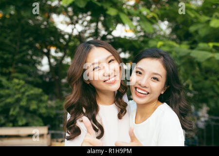 young pretty girlfriends over nature background, in the garden Stock Photo