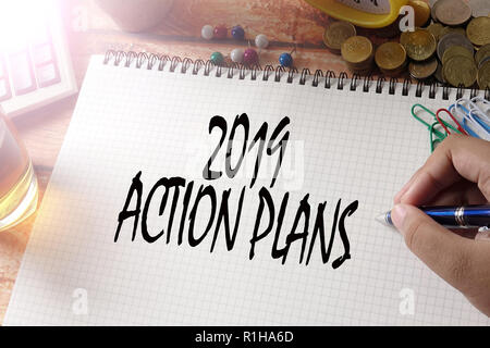 NEW YEAR CONCEPTUAL TEXT. Hand writing on notepad on a wooden table. Stock Photo