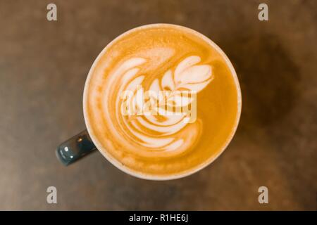 Top view, latte art, cup of coffee on the gray stone tabletop. Stock Photo