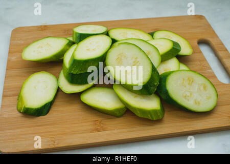 Sliced Zucchini on a Bamboo Cutting Board Stock Photo