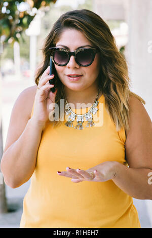 Young female business woman speaks on a cell phone Stock Photo