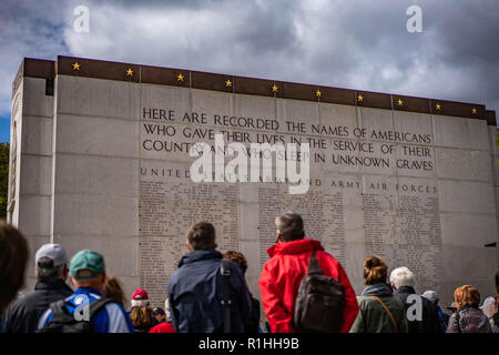 Group of visitors paying respects at the Luxembourg American Cemetery & Memorial, standing in front of a list of fallen soldiers. Stock Photo