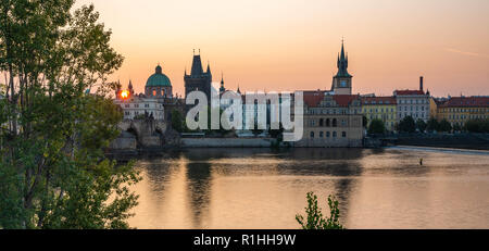 Old town view from across the Vltava River with dramatic Sunrise views of historical buildings in this popular destination. Stock Photo