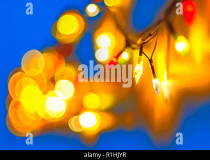 Decorative Colorful Blurred Lights On Blue Background. Christmas Abstract Soft Lights. Colorful Bright Circles Of A Sparkling Garland. Stock Photo