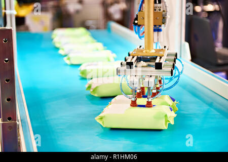 Hand robot manipulator for packaging products on conveyor Stock Photo