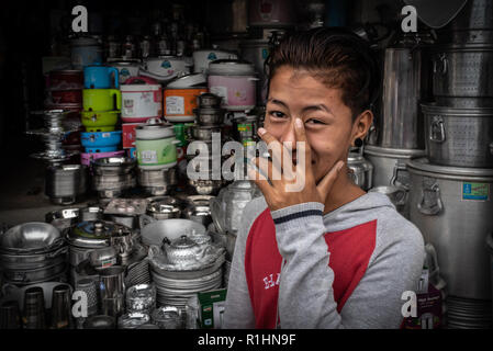 Portrait of a young Burmese man in front of the shop where he works, Mandalay, Myanmar. Stock Photo