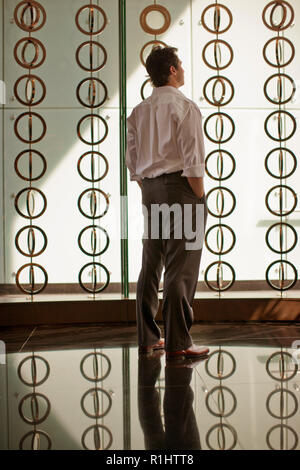 Thoughtful businessman standing in an office. Stock Photo