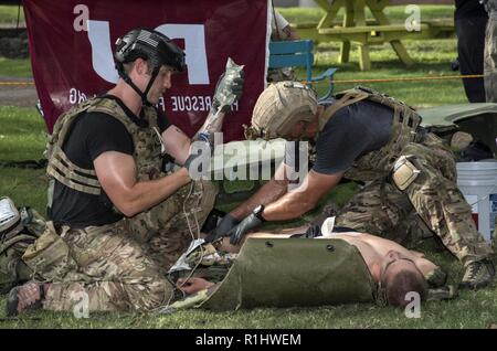 Pararescuemen perform battlefield trauma skills during the 2018 PJ Rodeo Sept. 19, 2018, at Travis Park in San Antonio, Texas. The PJ Rodeo is a friendly, but tough competition, tailored to test the skills, tactics, techniques and procedures being employed by today’s USAF Pararescuemen. Every two years, Active Duty, Air Force Reserve, Air Force Guard, and retired PJs gather to honor the legacy of USAF Pararescue, and to remember and celebrate teammates who gave all. Stock Photo