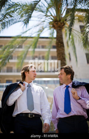 Two businessmen walking down steps in the city. Stock Photo