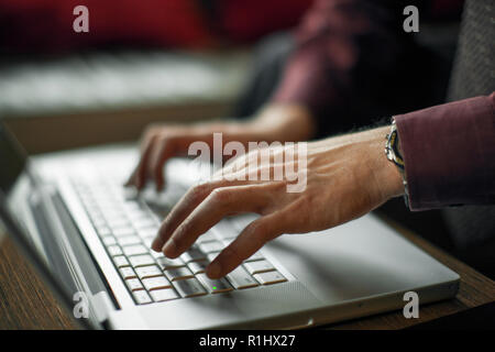 Woman's hands typing on a laptop keyboard. Stock Photo