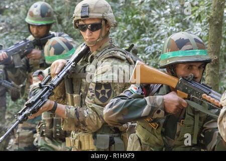 A Soldier with U.S. Army’s 1st Battalion, 23rd Infantry Regiment, and soldiers with Indian army’s 99th Mountain Brigade pull security during an IED training lane Sept. 21, 2018, at Chaubattia Military Station, India. This was part of Yudh Abhyas, an exercise that enhances the joint capabilities of both the U.S. and Indian army through training and cultural exchange, and helps foster enduring partnerships in the Indo-Asia Pacific region. Stock Photo