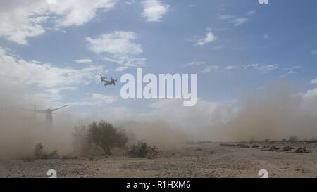 U.S. Marines with Alpha Company, 1st Battalion, 3d Marine Regiment, provide security after egressing from an MV-22B Osprey aircraft assigned to Marine Aviation Weapons and Tactics Squadron One (MAWTS-1) while conducting insertion operations in support of Weapons and Tactics Instructor (WTI) course 1-19 in Welton, Arizona, Sept. 19, 2018. WTI is a seven-week training event hosted by MAWTS-1 which emphasizes operational integration of the six functions of Marine Corps aviation in support of a Marine air-ground task force. WTI also provides standardized advanced tactical training and certificatio Stock Photo